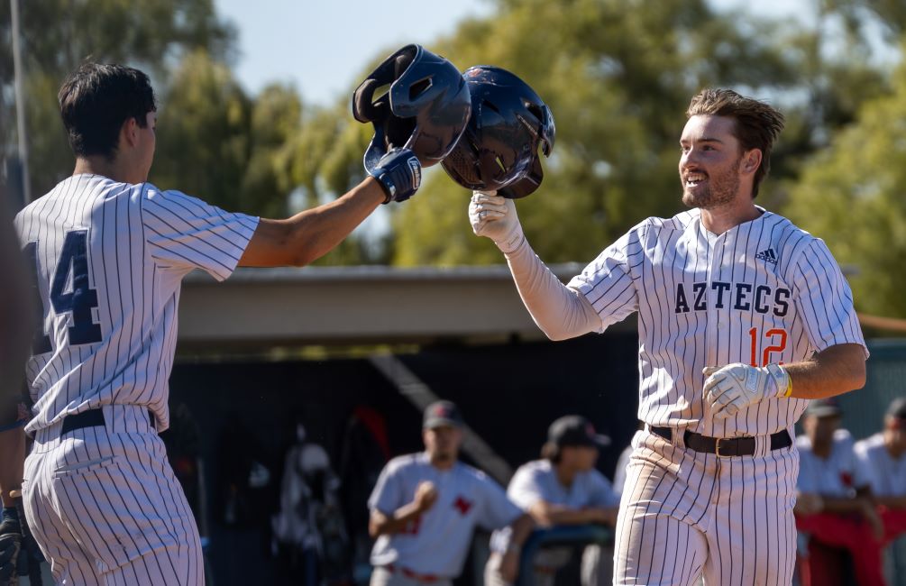 Sophomore David Shackelford (here being congratulated by sophomore Antonio Avila) hit a go-ahead leadoff home run in the 7th inning as the No. 2 seeded Aztecs baseball team took Game 1 against No. 3 Arizona Western College 7-6 to taker a 1-0 lead in the best-of-3 series. The Aztecs and the Matadors lock up for Game 2 on Friday at 2:00 p.m. at the West Campus Aztec Field. Photo by Gilbert Alcaraz