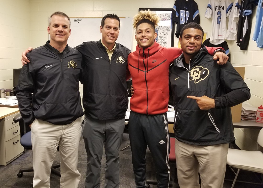 Freshman defensive back Aaron Maddox committed to play for the University of Colorado on Monday. Here with coaches Ross Els, D.J. Eliot and Shadon Brown. Photo by Raymond Suarez.
