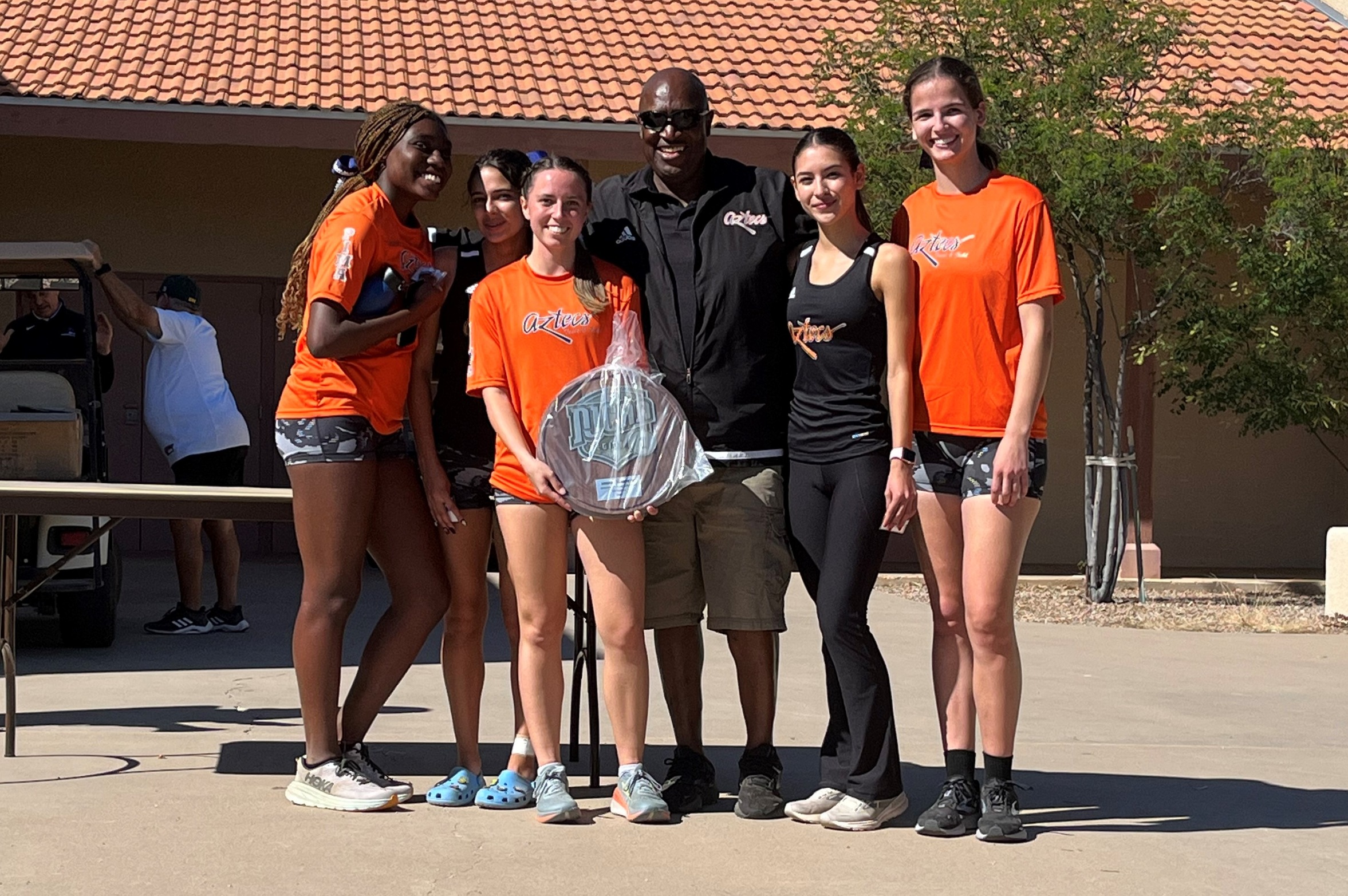 Aztecs Women's Cross Country took second place in Region I, Division I but were fifth in ACCAC conference. Marissa Lopez (Sahuarita HS), fifth from the left, earned both All-ACCAC and All-Region honors. (Left to right): Iyannah Tolliver, Naiomi Hereim, Kate Shoemaker, Coach Al Shirley, Marissa Lopez and Julian Lundberg. Photo by Raymond Suarez