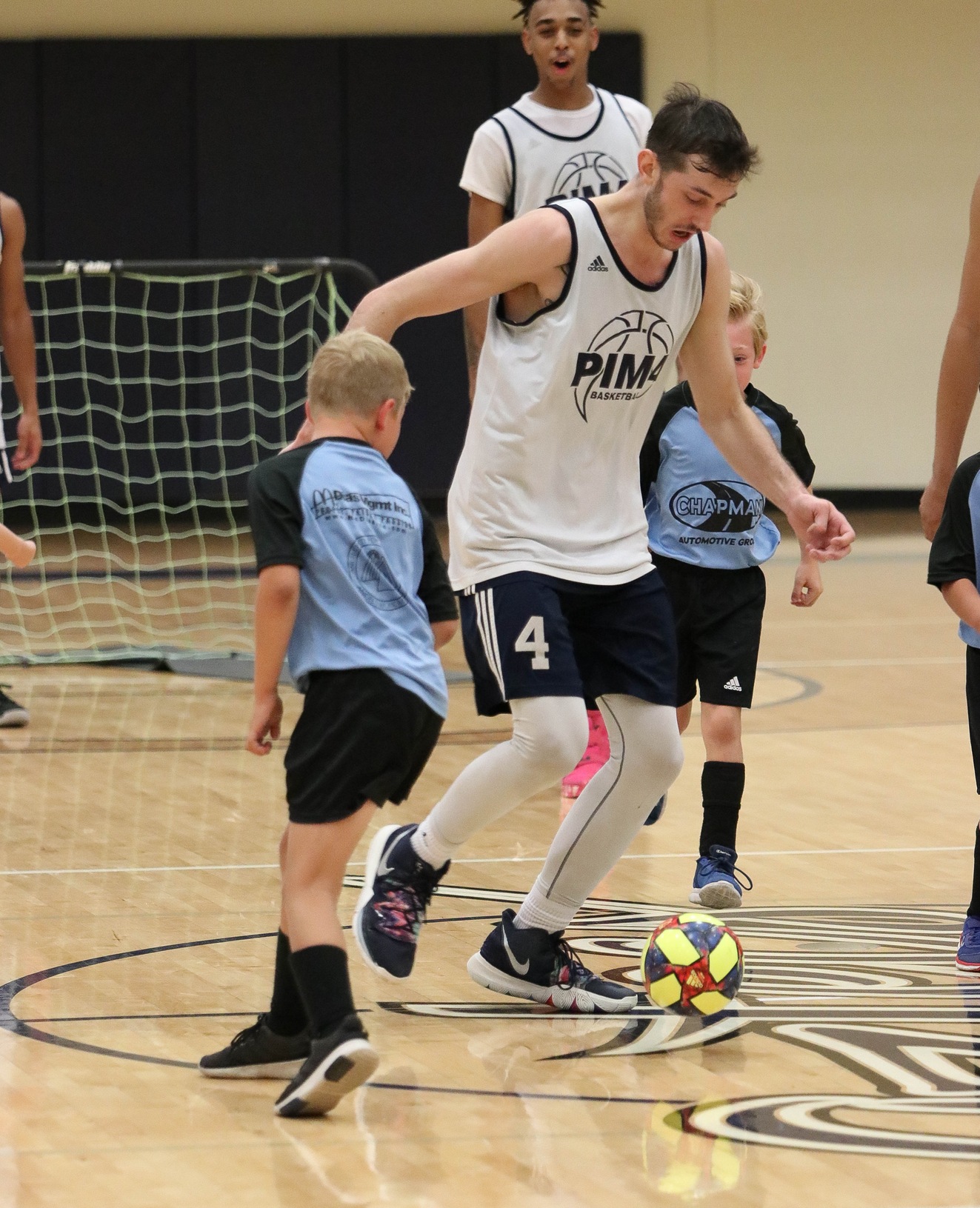 Men's Basketball plays min-soccer with Little Leaguers