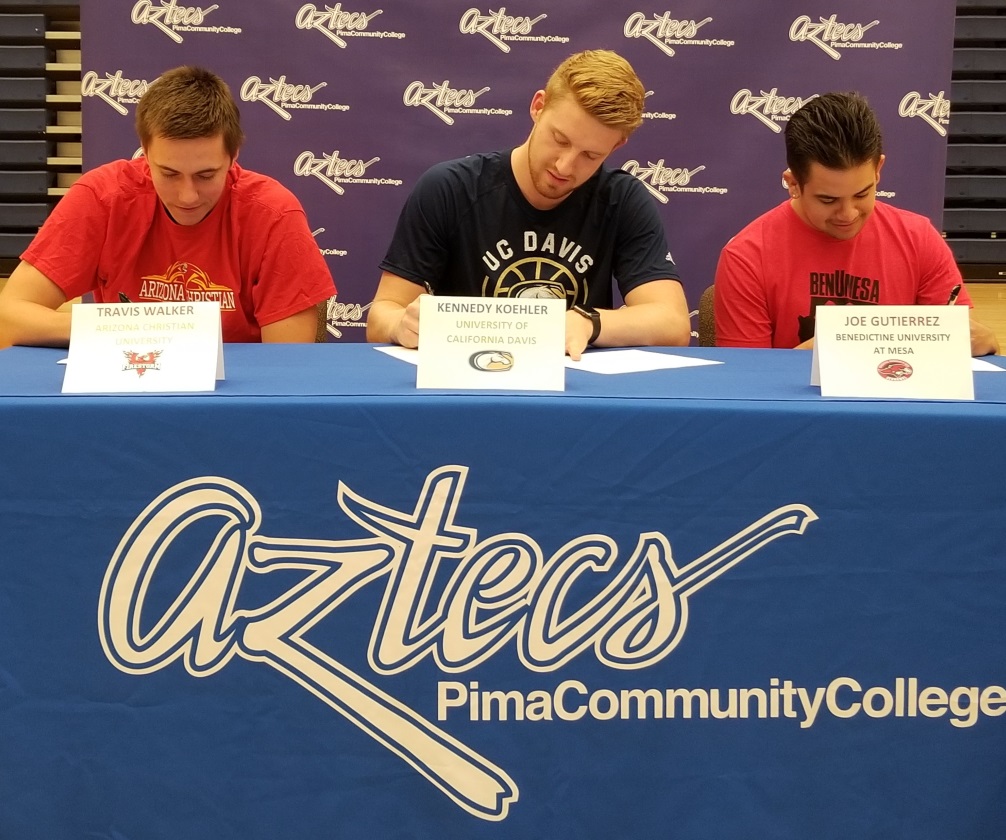 Basketball players Travis Walker and Kennedy Koehler, along with Team Manager Joe Gutierrez, signed their letters of intent to attend four year universities. Walker will play for Arizona Christian University while Koehler will play at University of California, Davis. Gutierrez will be the team manager for Benedictine University at Mesa. Photo by Raymond Suarez