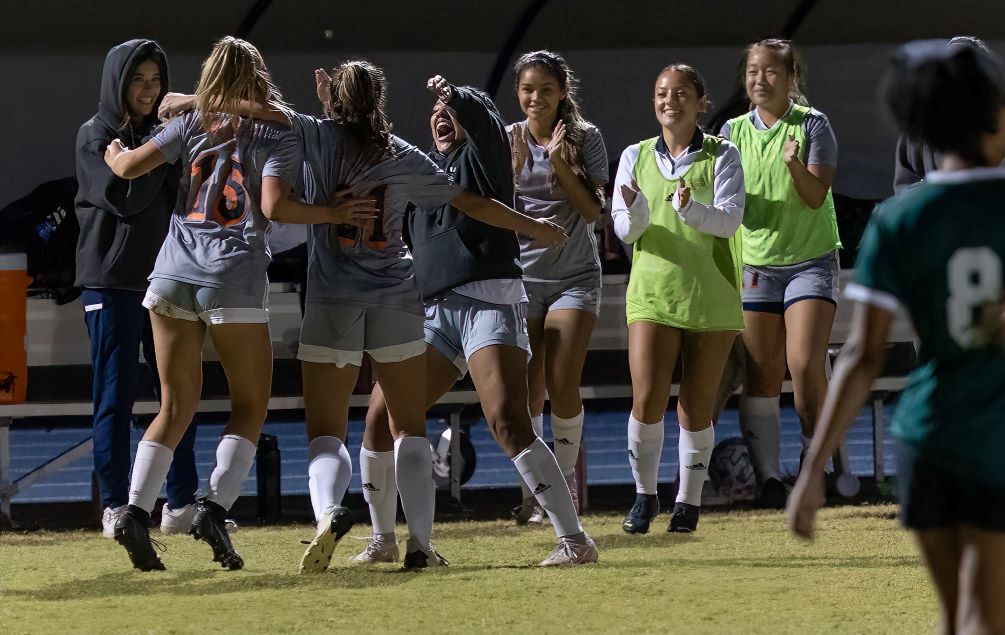 Teammates celebrate with sophomore Delaney Buntin (#15) and Meredith Scott (#21) after the Aztecs took the lead in the 48th minute. The No. 2 seeded Aztecs rallied with two unanswered goals to beat No. 3 seeded Scottsdale Community College 2-1. Scott scored both goals. Pima will play at No. 1 Phoenix College on Saturday in the NJCAA Region I, Division II Finals. Photo by Stephanie van Latum