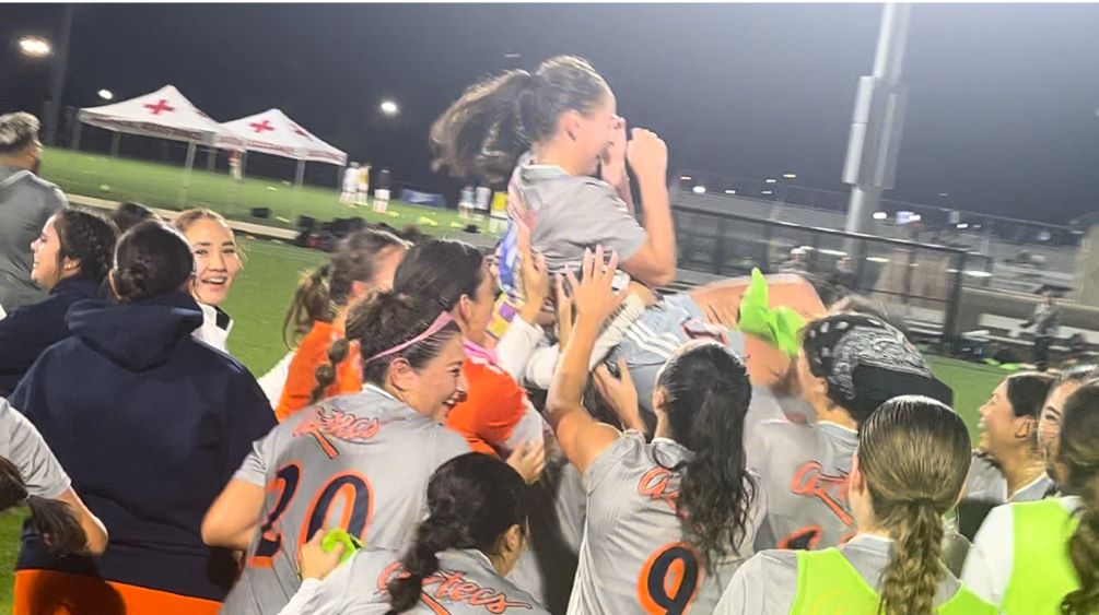 The (6) Aztecs Women's Soccer team celebrates and hoists up sophomore Solaris Graves (Ironwood Ridge HS) after rallying from 2-0 and 3-2 deficits to beat (10) Pensacola State College 4-3. Graves scored the game-tying goal in the 86th minute. The Aztecs are 13-5 and await the result of Wednesday's Pool C matchup between Heartland Community College and Pensacola State College to see if they advance to the National Semifinals. Photo by Ray Suarez